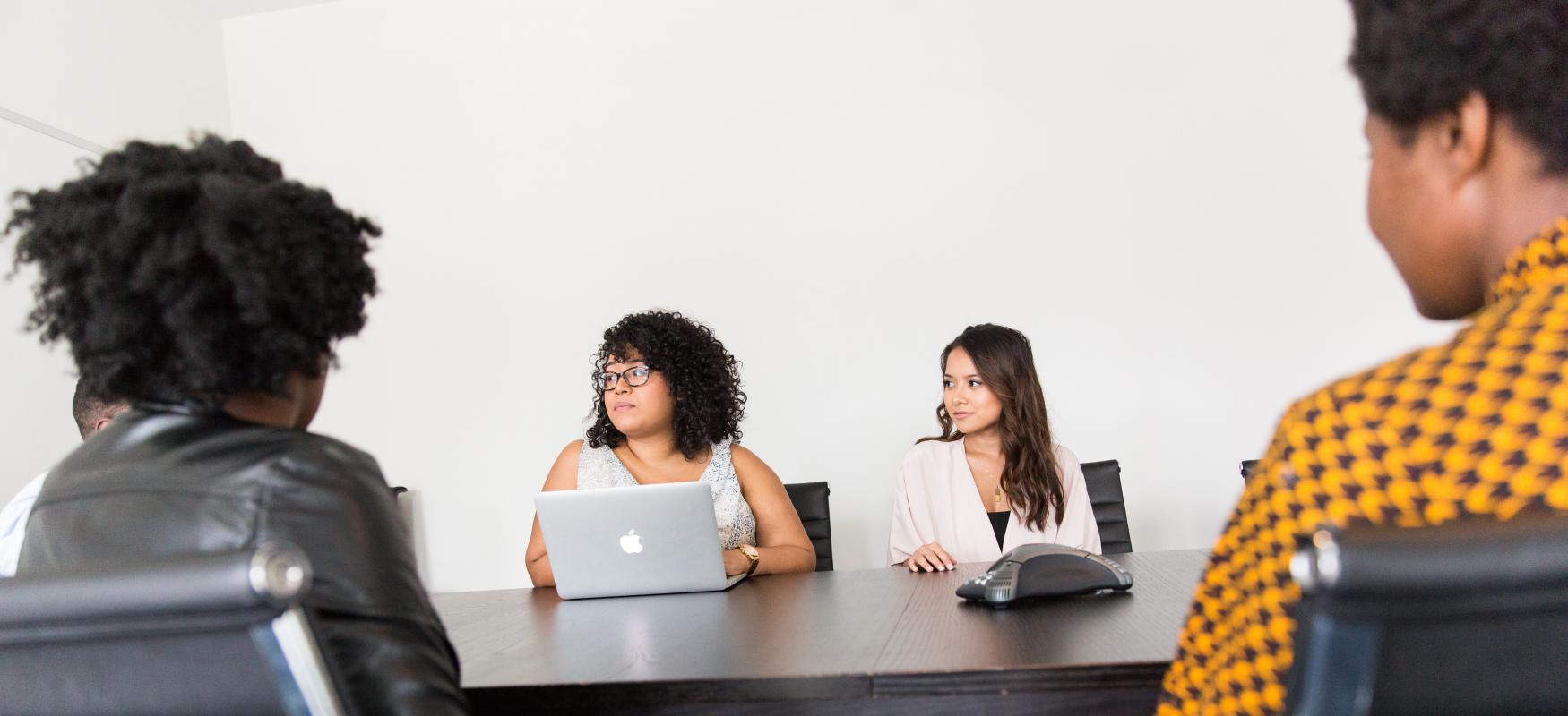 4 women sitting around a table