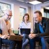 Three participants from batch 3 of Nordic Scalers in front of a computer.