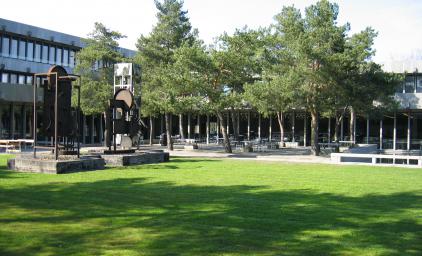 The DTU building in Konges Lyngby, sunny day with trees in the front of the building.