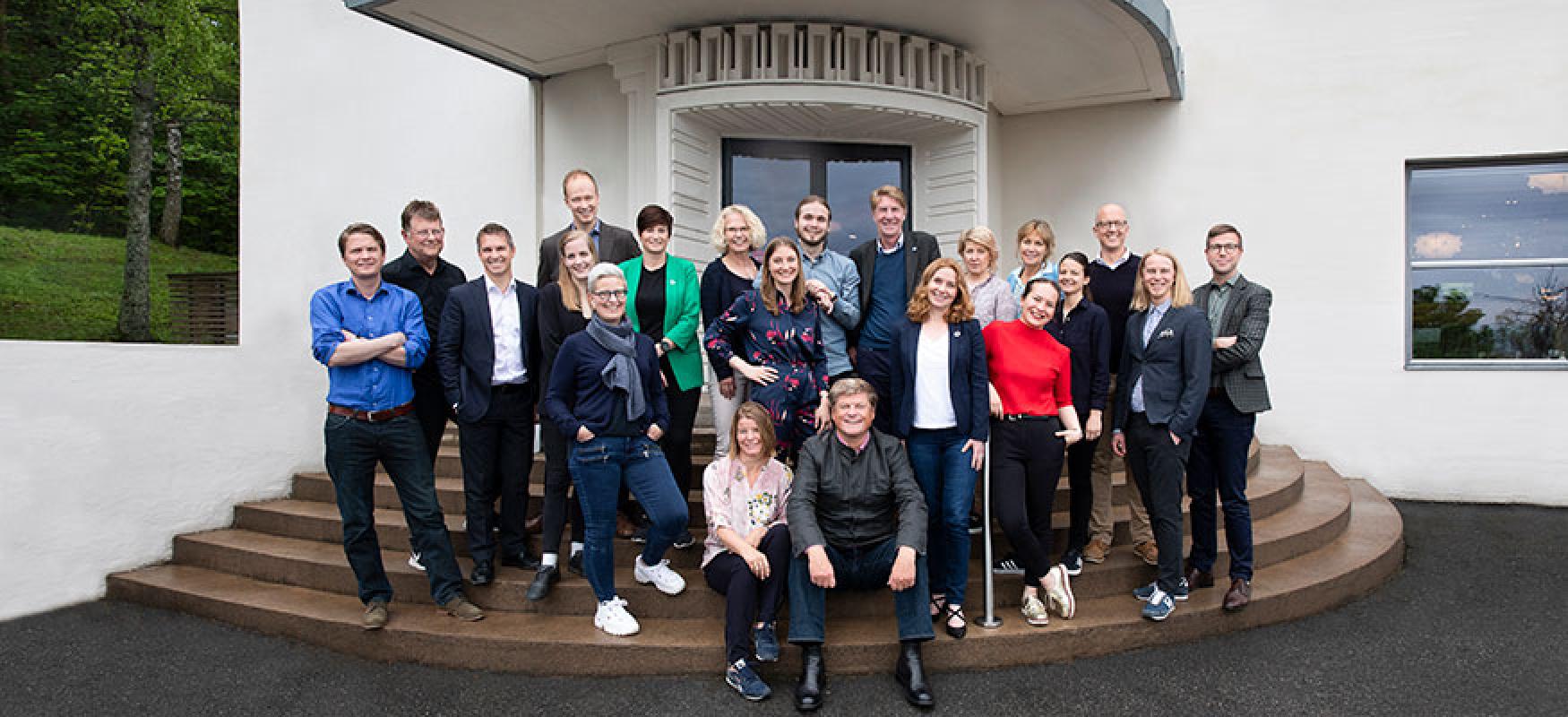 Group of people standing on stairs.