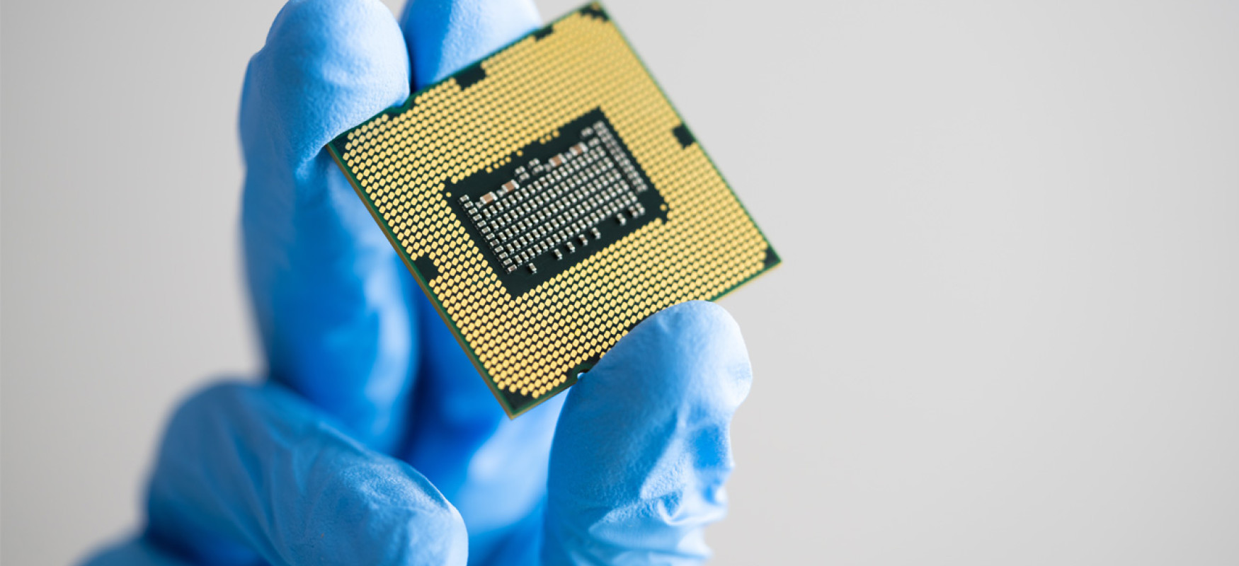 hand holding up a semi conductor chip