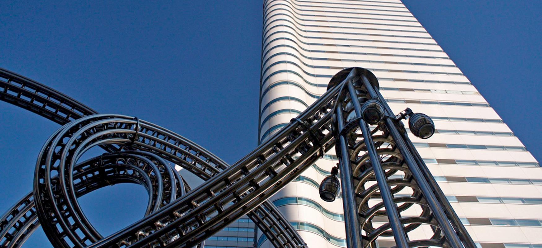 Part of a rollercoaster in front of an office building in Yokohama, Japan.