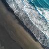 Areal view of waves washing in on a beach 